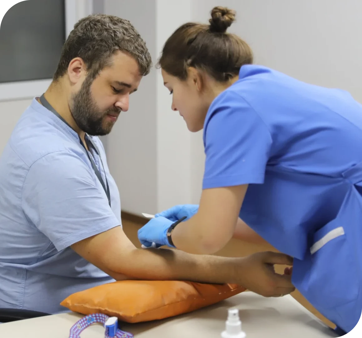Medical staff performing blood draw procedure