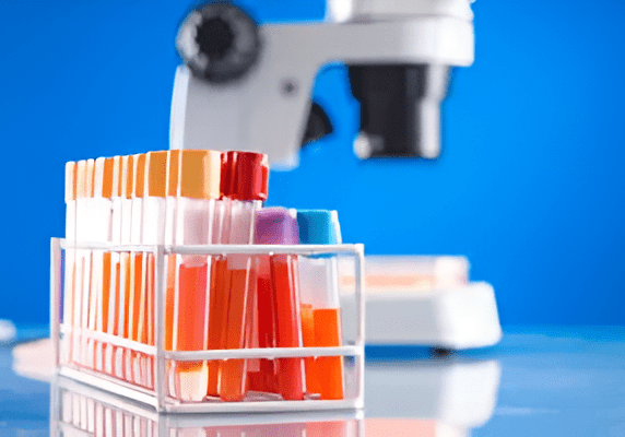 Colorful test tubes with a microscope