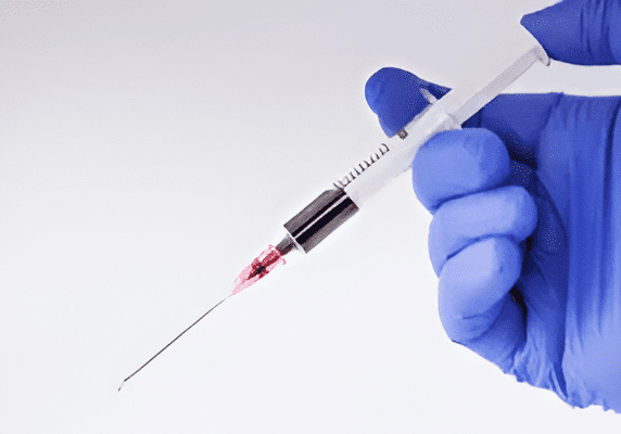 Medical syringe with red liquid